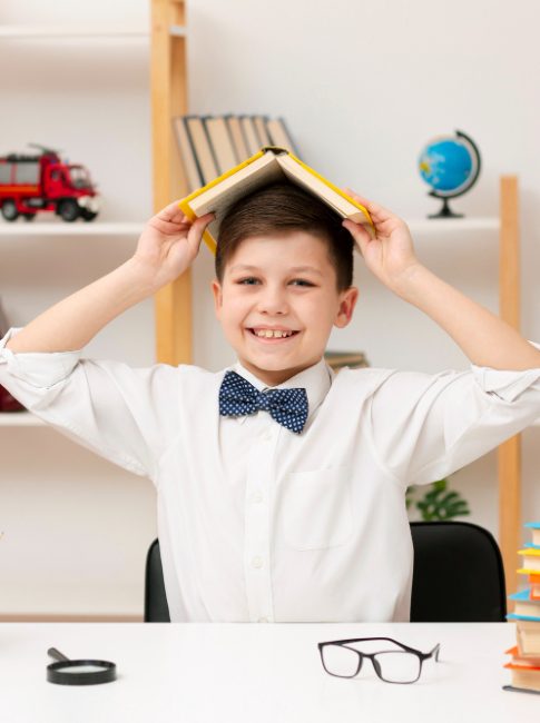 playful-boy-playing-with-book